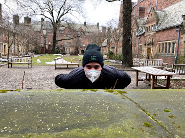 Guy wears black JE Beanie on campus
